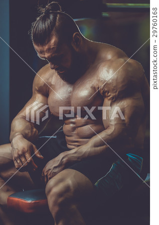 Handsome athletic man training pumping up muscles 29760168