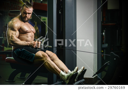 Handsome athletic man training pumping up muscles 29760169