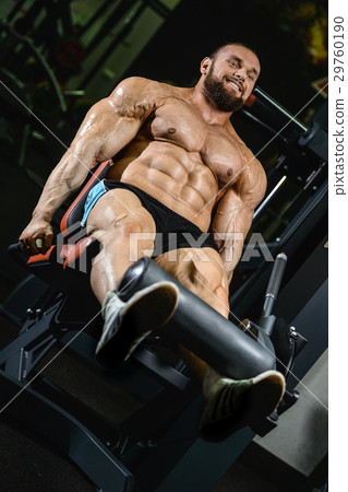 Handsome athletic man training pumping up muscles Handsome athletic man training pumping up muscles 29760190