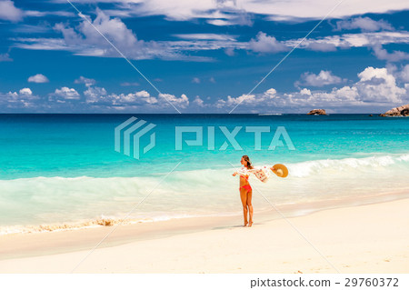 Woman with sarong on beach at Seychelles Woman with sarong on beach at Seychelles 29760372