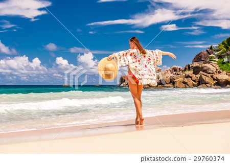Woman with sarong on beach at Seychelles Woman with sarong on beach at Seychelles 29760374