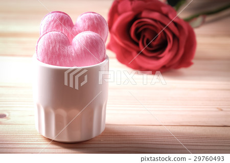 2 hearts in white glass on the wooden floor 2 hearts in white glass on the wooden floor 29760493