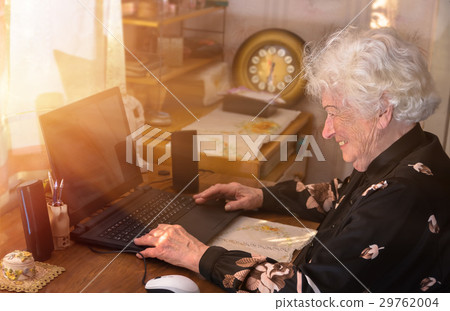 Grandmother learns to work at home on the computer 29762004
