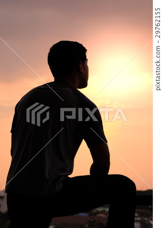 The silhouette of a man puts his arms on a leg The silhouette of a man puts his arms on a leg 29762155