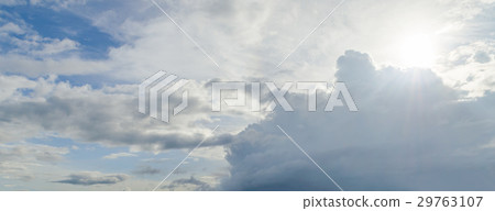 Sun and beam behind the white cloud 29763107
