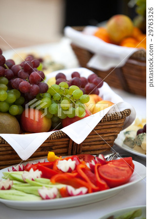 Basket of fresh organic fruits from grapes and 29763326