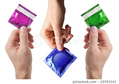 set of colored condom in female and man's hands set of colored condom in female and man's hands 29763341