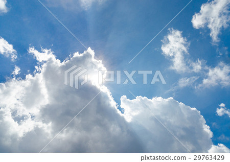Sunbeam behind the white cloud and blue sky 29763429