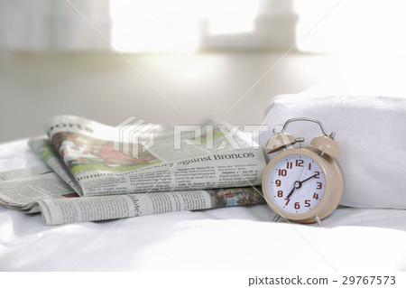 Alarm clock (07:10) and English newspaper Alarm clock (07:10) and English newspaper 29767573