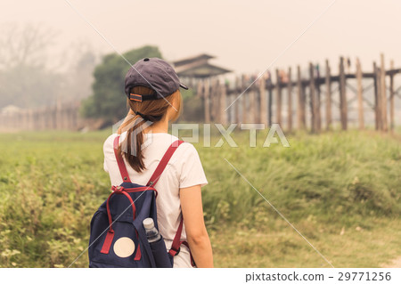 Young women traveler looking at U bein bridge 29771256
