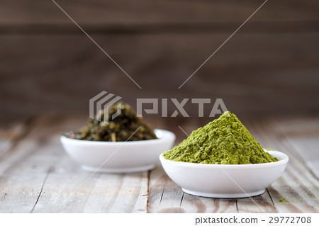 Green tea powder with dried tea in white cup. Green tea powder with dried tea in white cup. 29772708