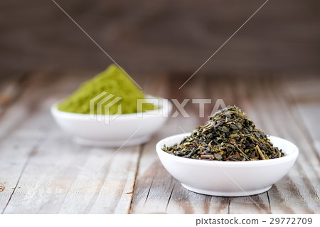 Dried tea with Green tea powder in white cup. Dried tea with Green tea powder in white cup. 29772709