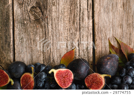 Figs halves with grape on wood flat lay 29774755