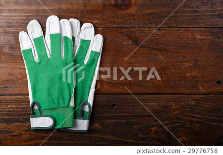 Construction gloves on a wooden background Construction gloves on a wooden background 29776758