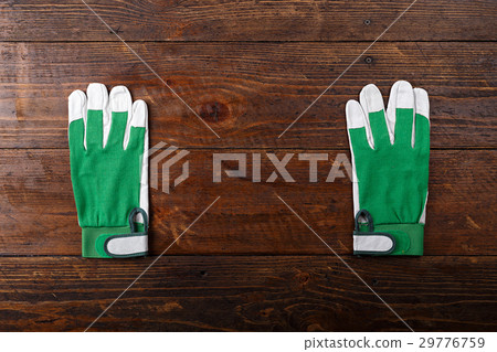 Construction gloves on a wooden background 29776759