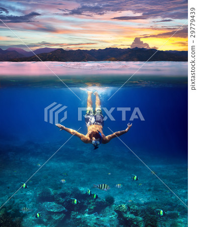 Underwater shoot of a young man snorkeling in a tropical sea and Underwater shoot of a young man snorkeling in a tropical sea and 29779439