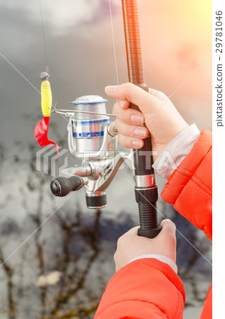 Female hands holding a fishing rod and lure. Female hands holding a fishing rod and lure. 29781046