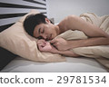 Young Asian man smilingwhile sleeping 29781534