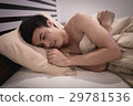 Young Asian Caucasian man on bed 29781536