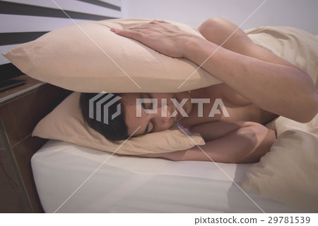 Young Asian Caucasian man on bed 29781539