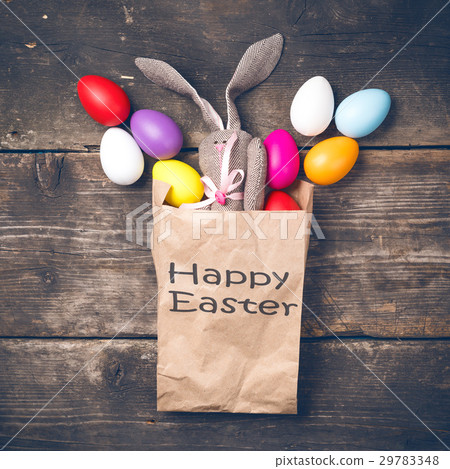 Easter bunny in a paper bag on old boards 29783348