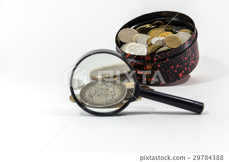 silver coin under a magnifying glass 29784388
