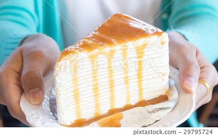 Closeup woman holding crape cake caramel 29795724