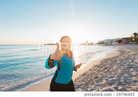 Successful female athlete doing positive thumbs up Successful female athlete doing positive thumbs up 29796885