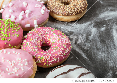 Donuts in a glaze assorted on a black  29796898