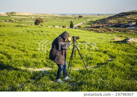 A photographer or traveller using a professional 29796907