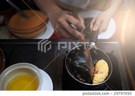 Chef putting egg to pan. 29797095