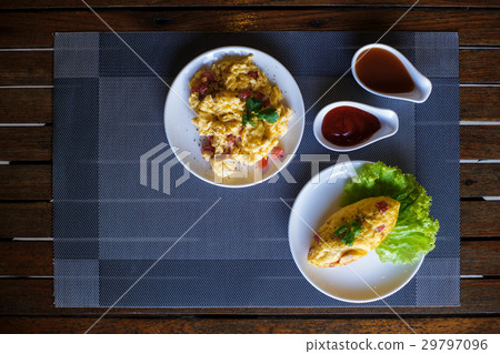 scrambled eggs and omelet on the table. 29797096