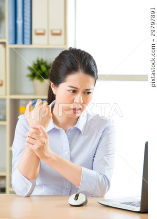 Young asian business woman with pain in wrist 29797891