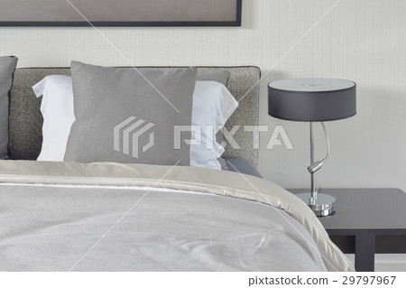 gray pillow with comfy bed and black reading lamp 29797967