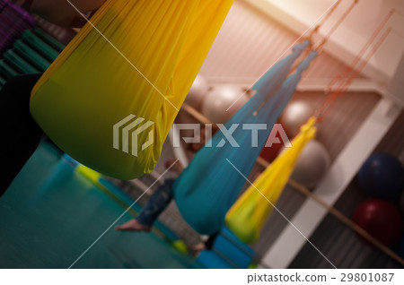 Women practicing yoga fly in hammocks 29801087