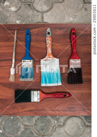 Paint brushes on the old wooden background Paint brushes on the old wooden background 29803811