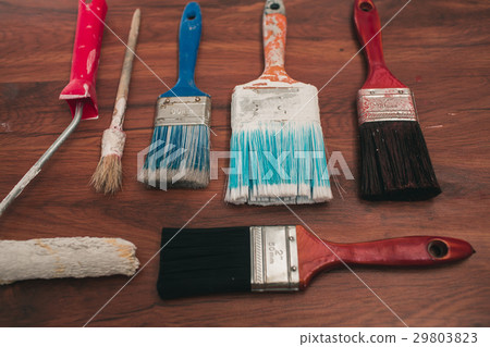 Paint brushes on the old wooden background 29803823