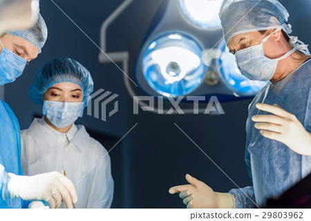 Serious doctors in operating theatre Serious doctors in operating theatre 29803962
