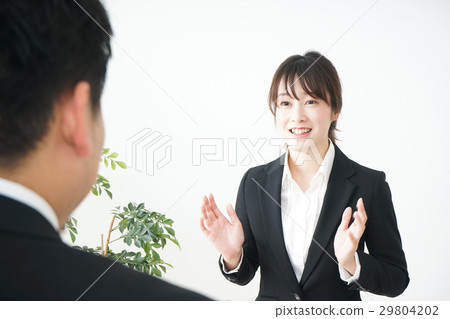 A young Japanese woman receiving an interview A young Japanese woman receiving an interview 29804202