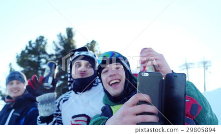 Group of young snowboarders on the slopes in sunny Group of young snowboarders on the slopes in sunny 29805894