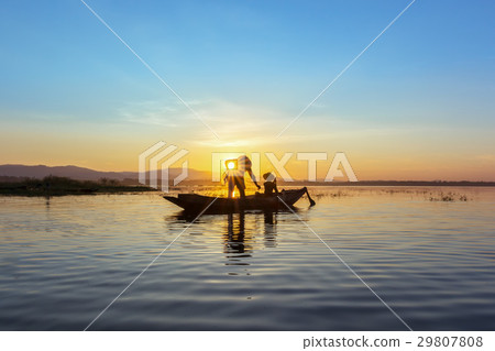 Silhouette fisherman on the boat setting net Silhouette fisherman on the boat setting net 29807808