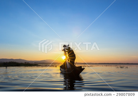 Silhouette fisherman on the boat setting net Silhouette fisherman on the boat setting net 29807809