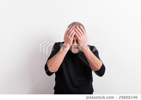 Upset senior man with headache, holding his head 29808146