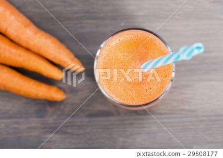 A glass of healthy carrot smoothie 29808177