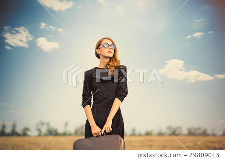 photo of beautiful young woman with suitcase 29809013