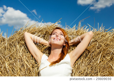photo of beautiful young woman lying on the hay photo of beautiful young woman lying on the hay 29809030