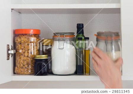 food cupboard, pantry with jars, hand 29811345