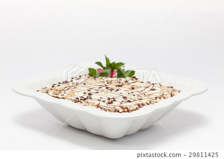 Decorated Napoleon dessert in a white bowl 29811425