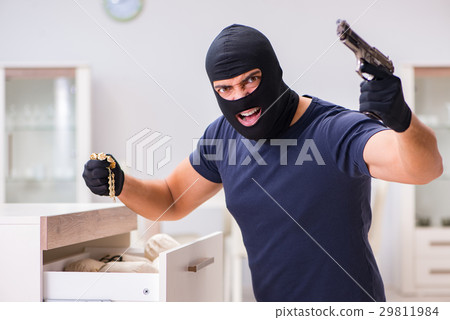 Robber wearing balaclava stealing valuable things Robber wearing balaclava stealing valuable things 29811984