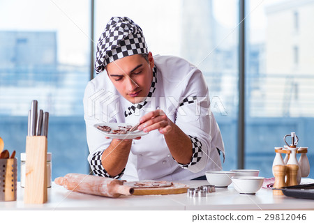 Young man cooking cookies in kitchen 29812046
